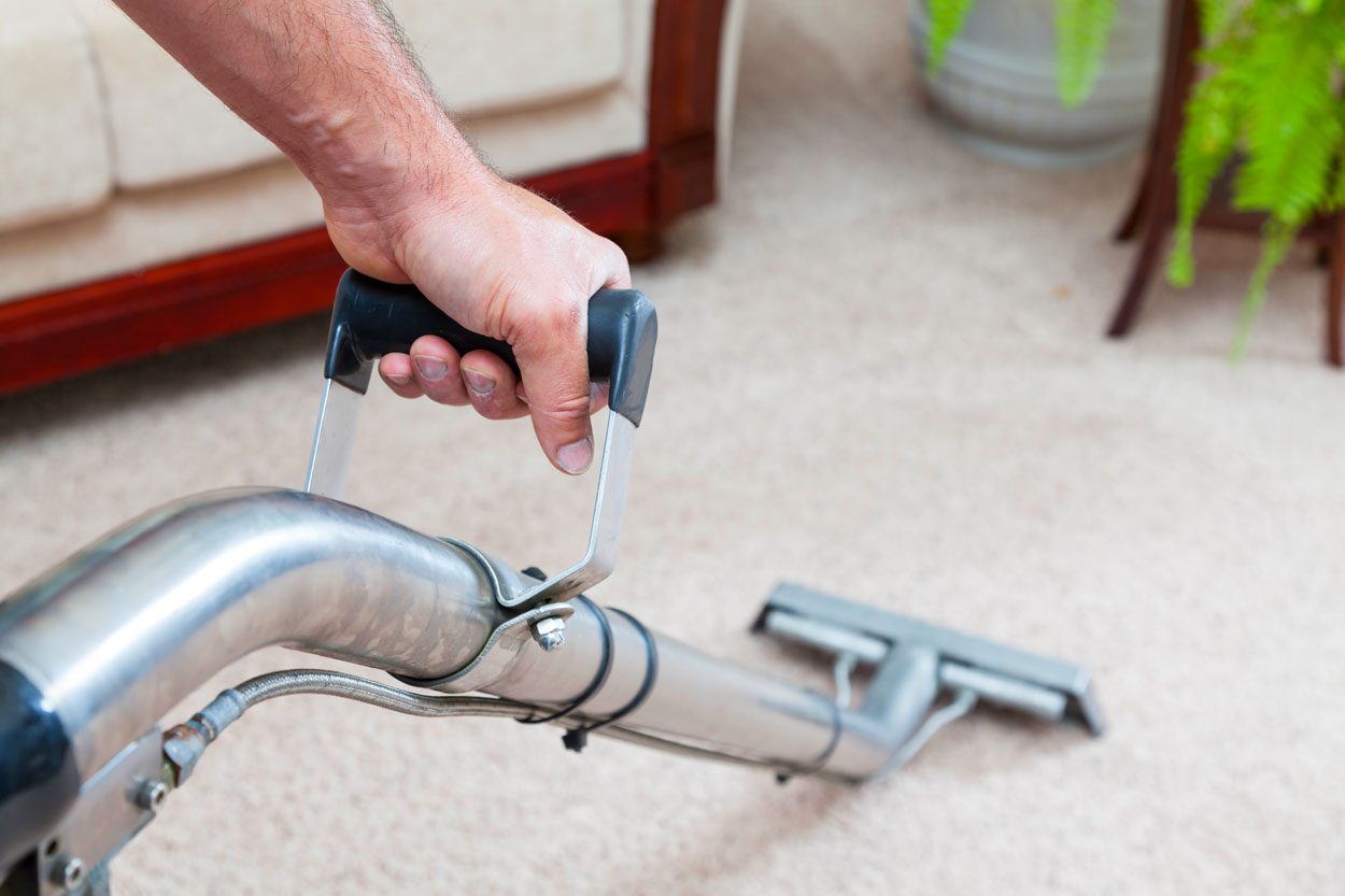 Man Steam Cleans Carpets in a residential setting