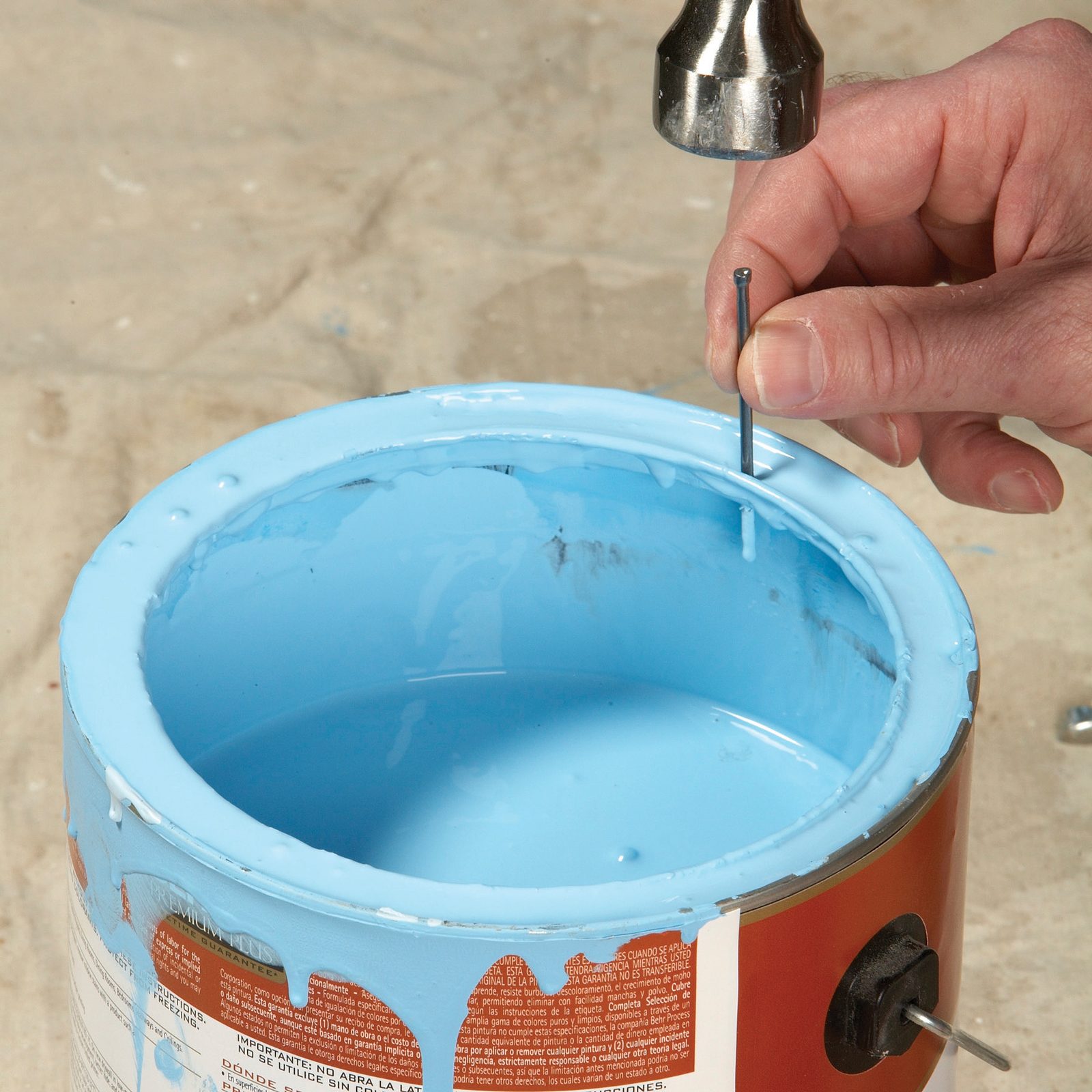 hammer nail into side of painty paint can