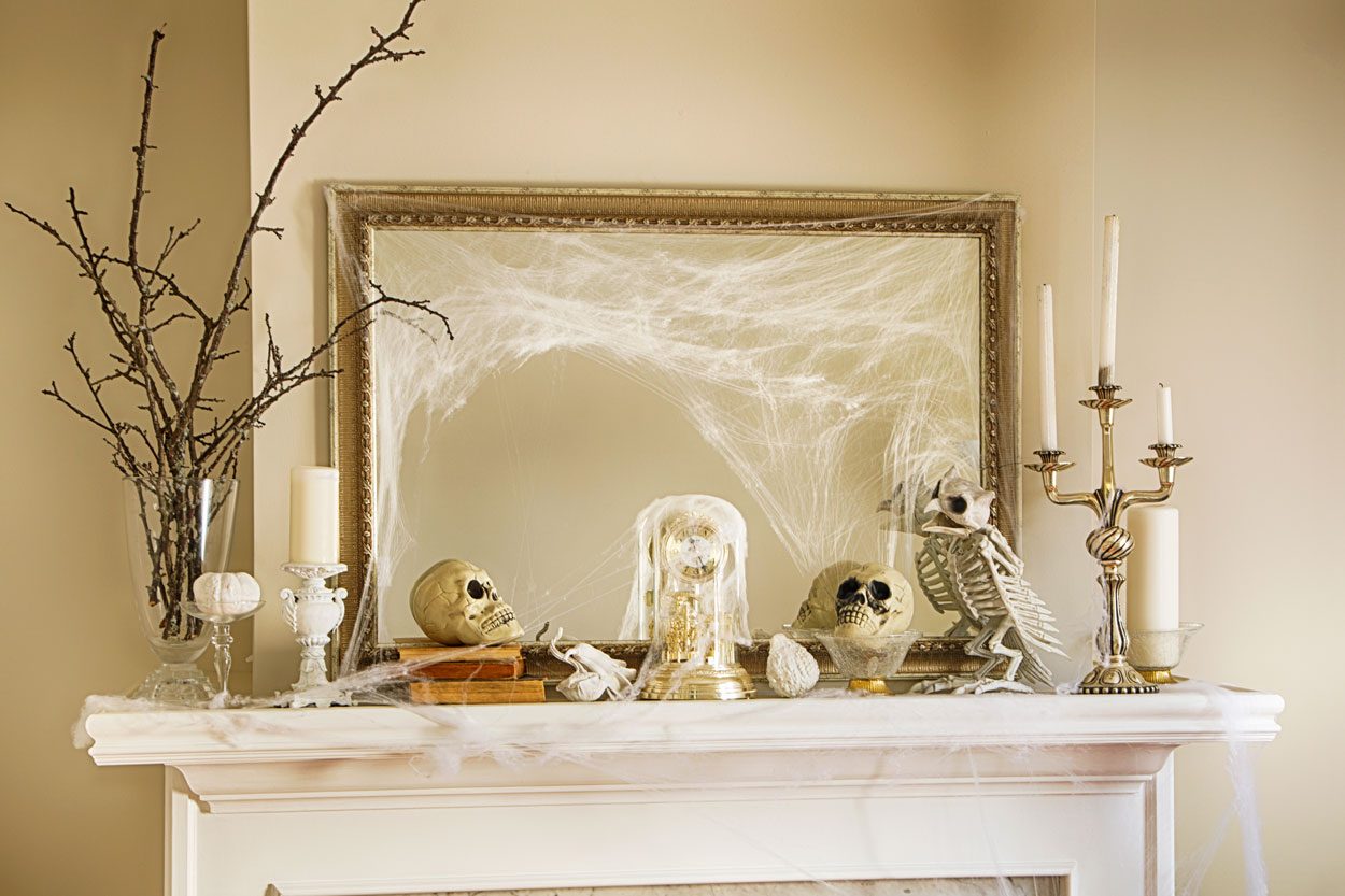 Fireplace Halloween Decorations with assorted skulls, cobwebs and fall decorations