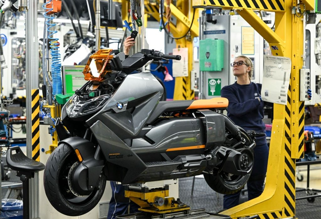 BMW Trainee Worker assists on the production of an electric BMW CE 04 at a Berlin, Germany Plant