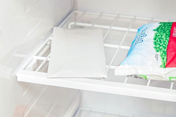 An Envelope and Packet of Green Peas in Freezer, Why You Should Put An Envelope In The Freezer