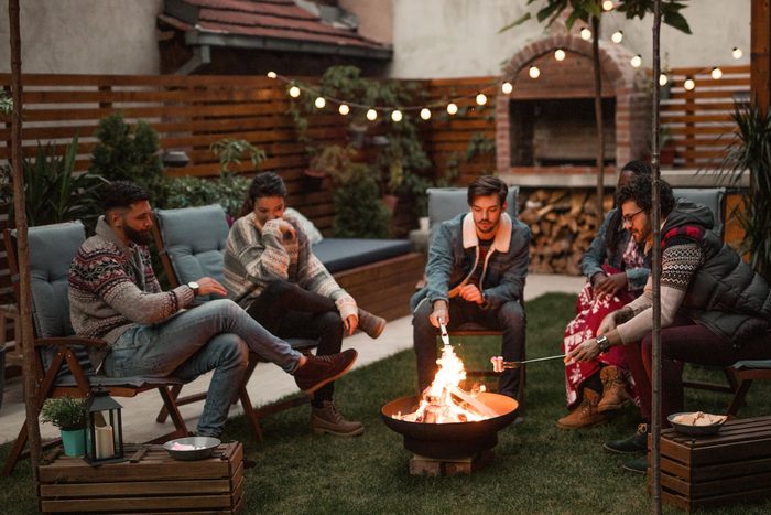 Group of Friends enjoy a Relaxing Evening By The Fire