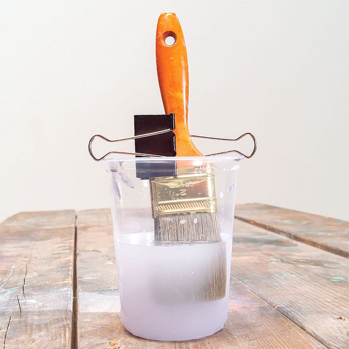Paint Brush Soaking in a Jar Clipped with a Binder Clip