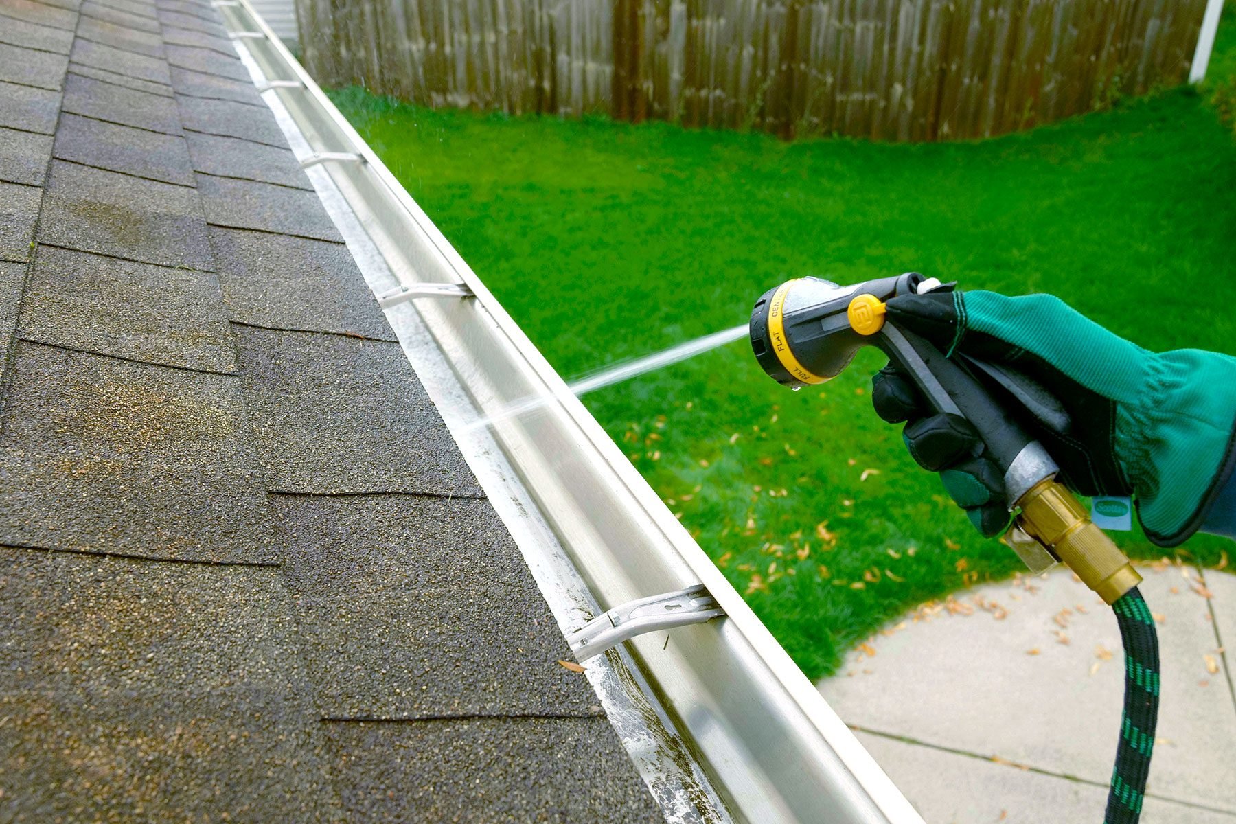 Flush out gutters by spraying water