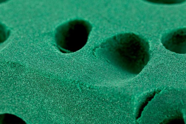 A used Green Floral Foam sponge Brick, isolated background