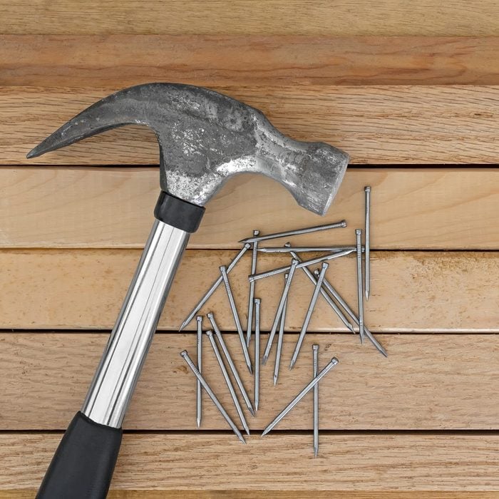 Hammer and nails with wood planks