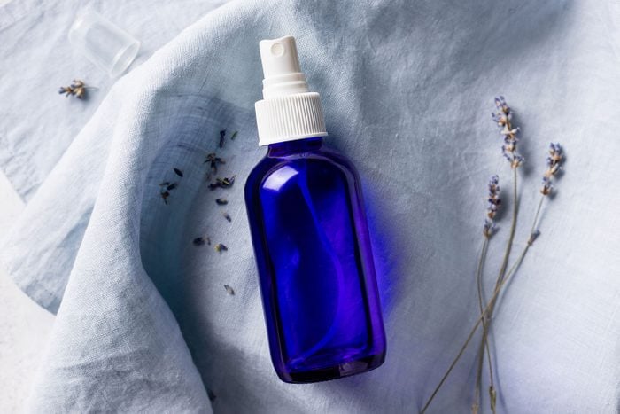 Lavender Spray In Transparent Glass Bottle On Linen Sheet