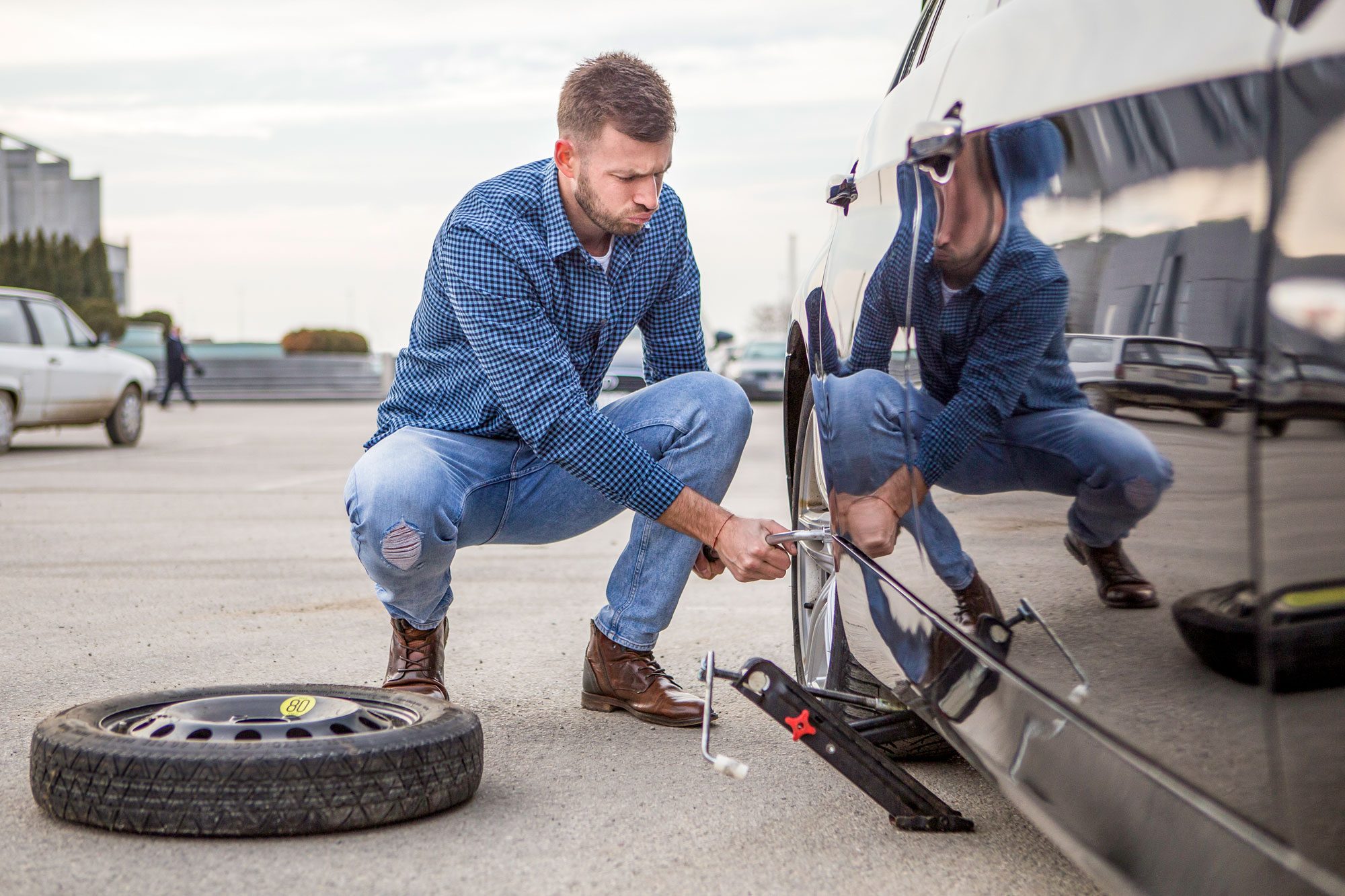 Man Changing A Flat Tire