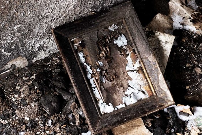 Charred Picture Frame after a House Fire Ravages a Family Home