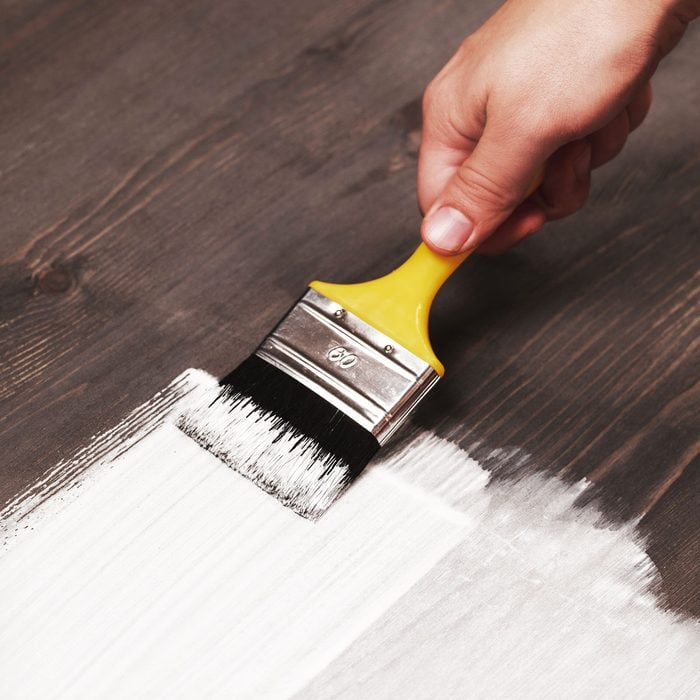 Painting White Color On Wooden Table With Paint Brush