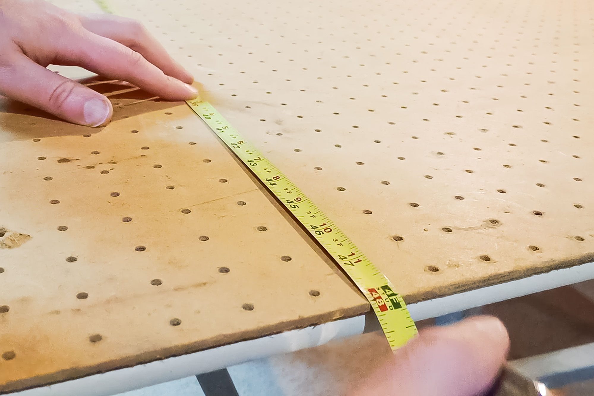 Measuring A Pegboard With Measuring Tape