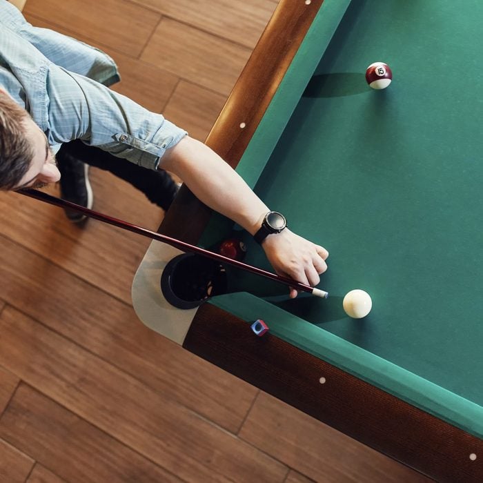 Top view of man playing billiards
