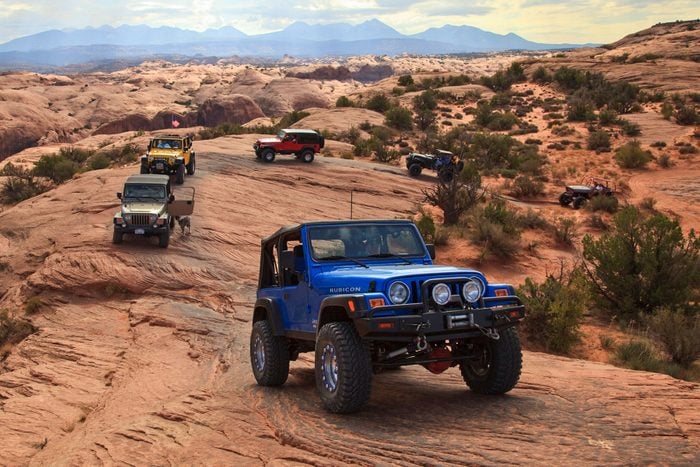 Multiple jeeps climbing up mountains