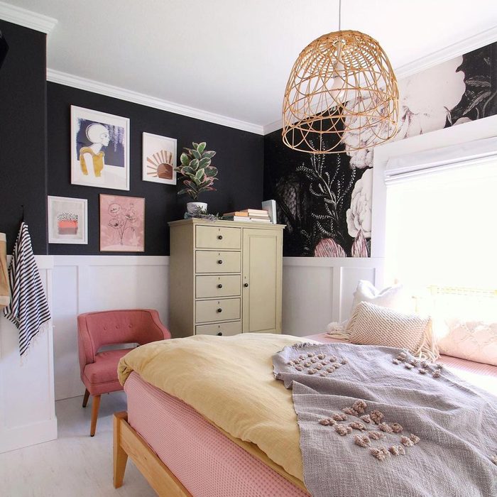 A room with white wainscoting and black walls