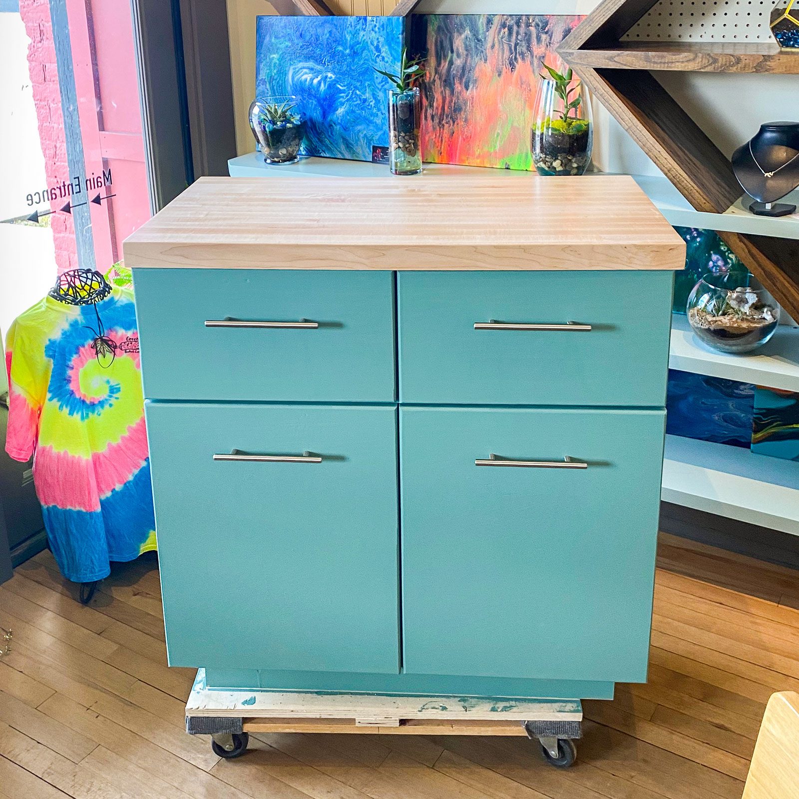 A turquoise kitchen storage cabinet in a store