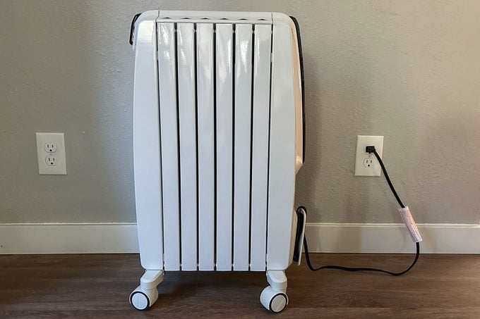 Side view of space heater on wooden floor