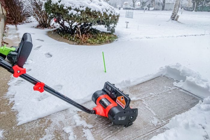 Voltask 12 Inch Cordless Snow Shovel in driveway