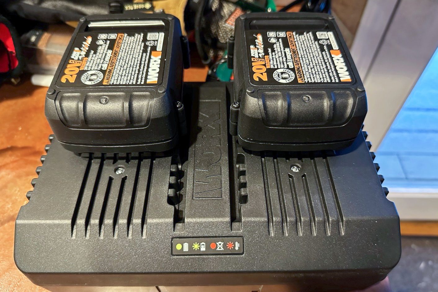 Two batteries plugged in a charger