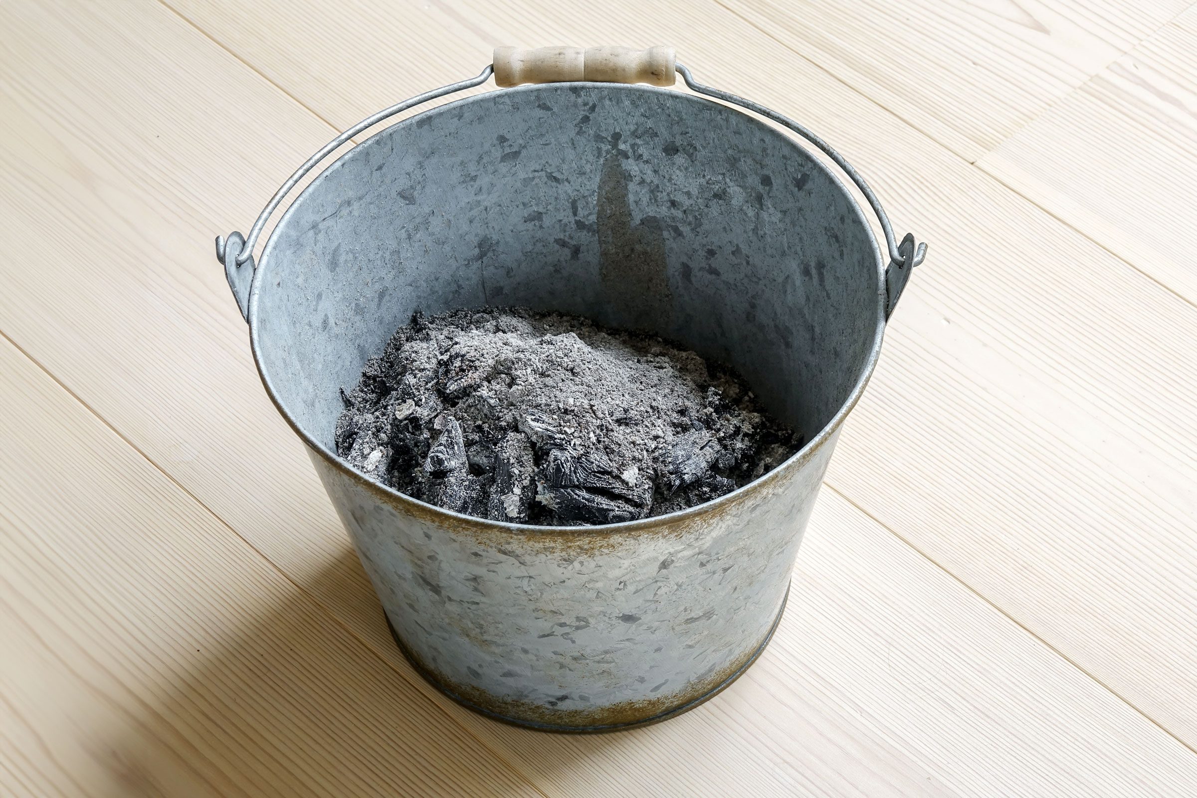ashes in a bucket on wood