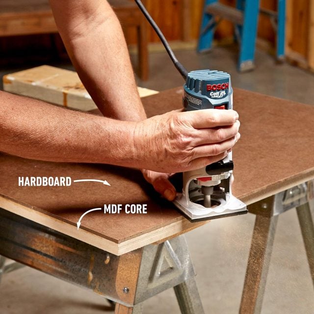 A man is using a sander on a piece of wood.