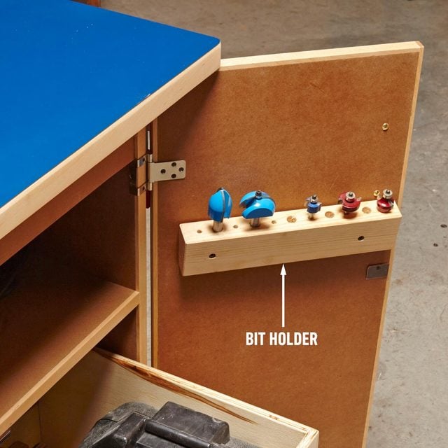 A wooden router table with two drawers and a tool holder super storage unit.