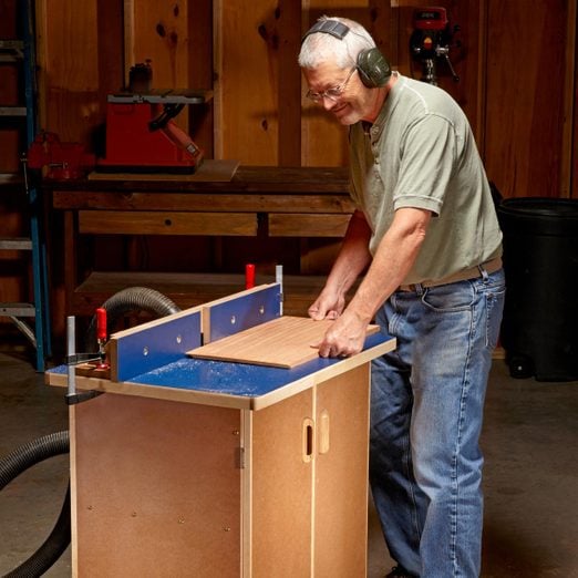 Dave Munkittrick is using a table saw to cut a piece of wood.