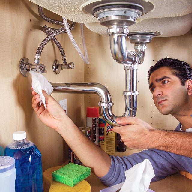 Wiping Water Supply Tap Under The Sink with A Dry Tissue