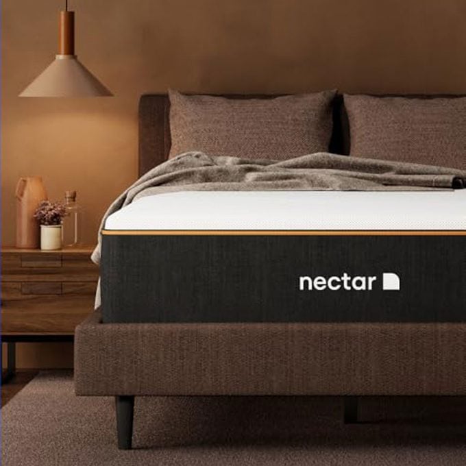 Nectar Premier Copper 14 Queen Mattress with a lamp in a bedroom