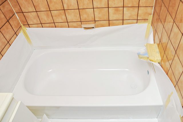 Reglazing A Tub Bathtub Being Renovated And Protective Paper Around The Walls