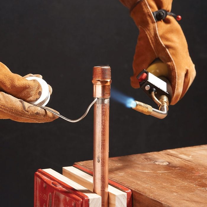 Working on a copper pipe with a torch