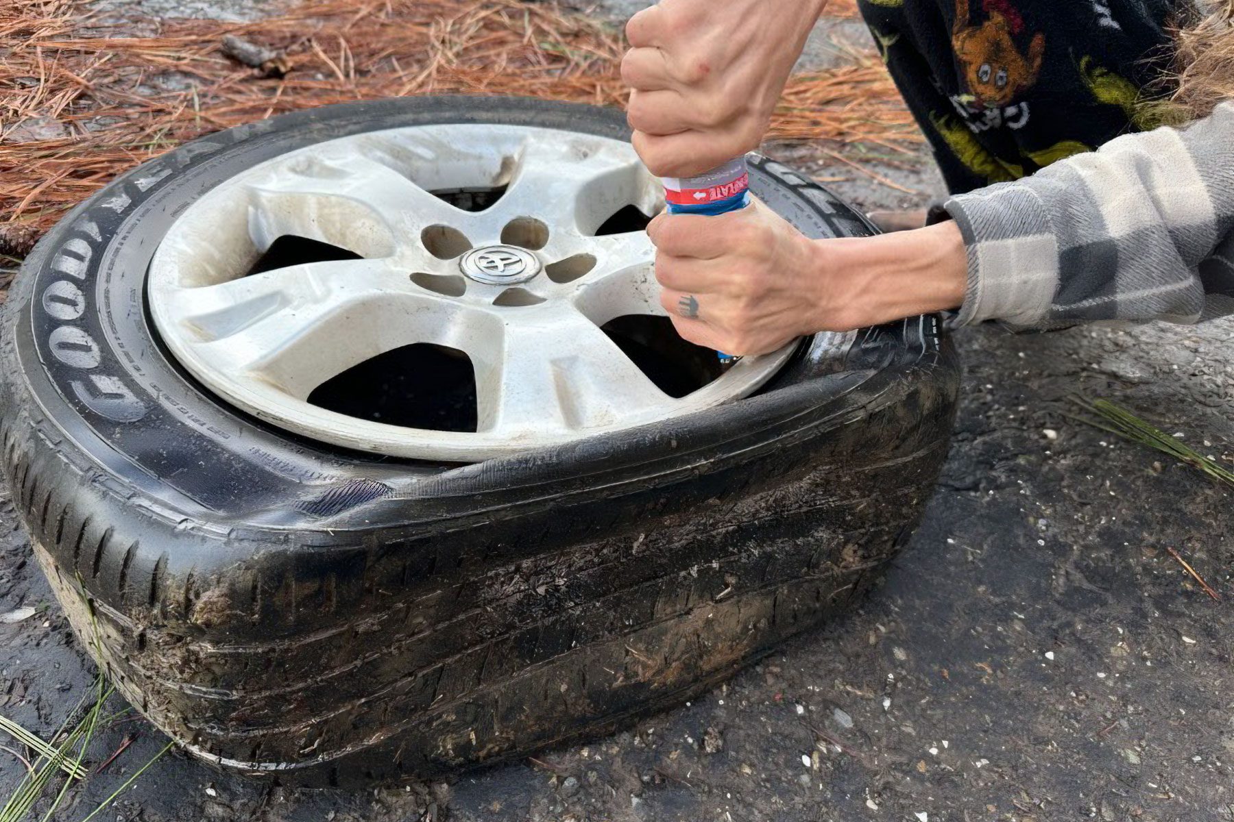 A person repairing a tyre outdoors