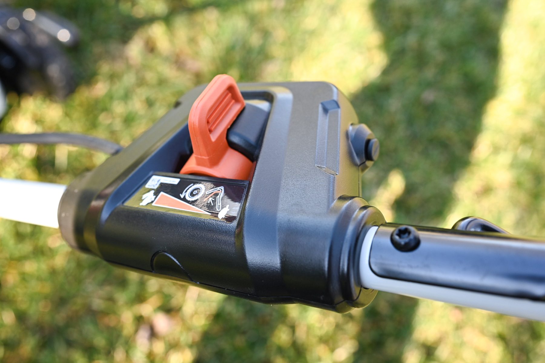 A closeup of a switch on a lawn mower