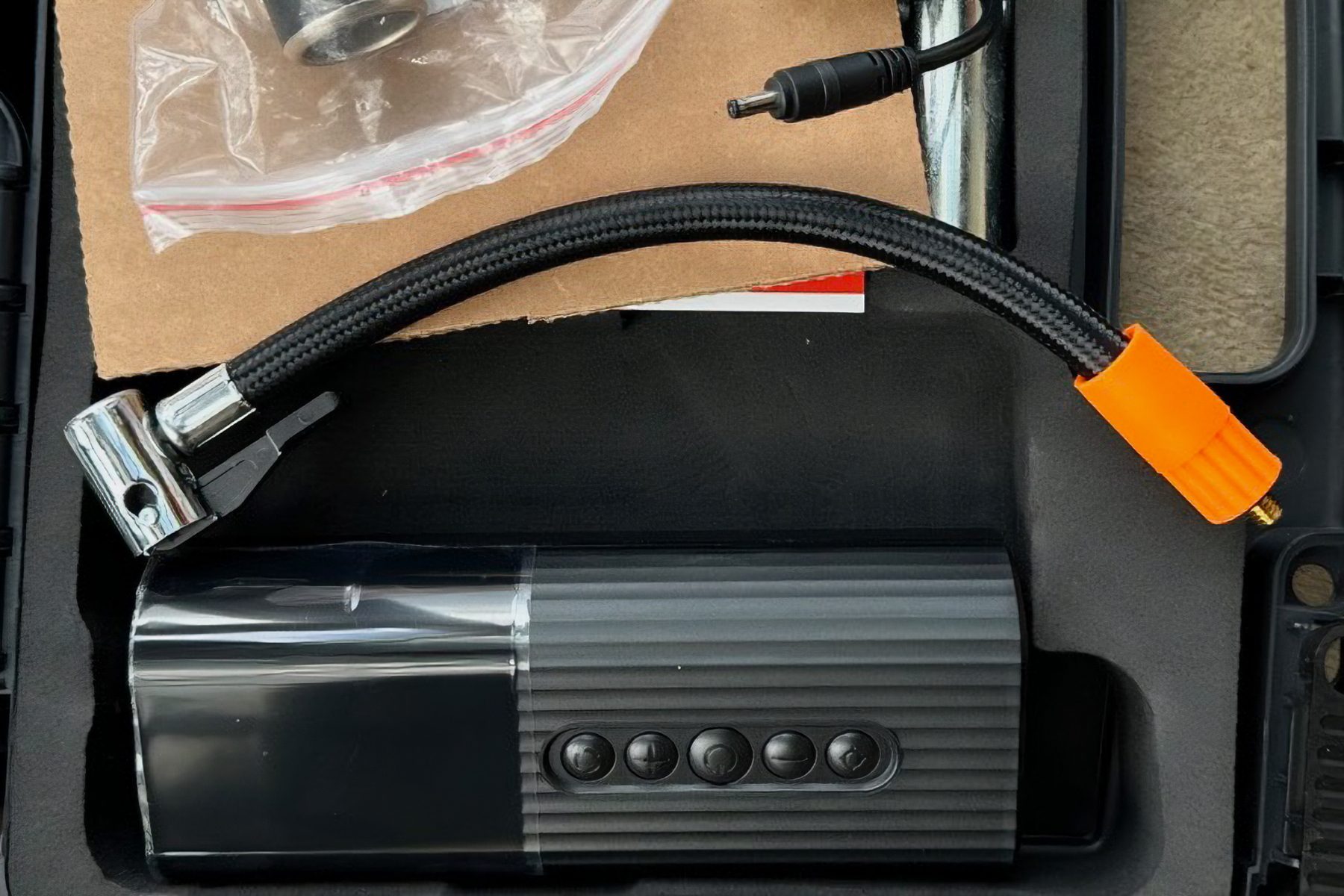 Electric tire inflator in a tire repair took kit