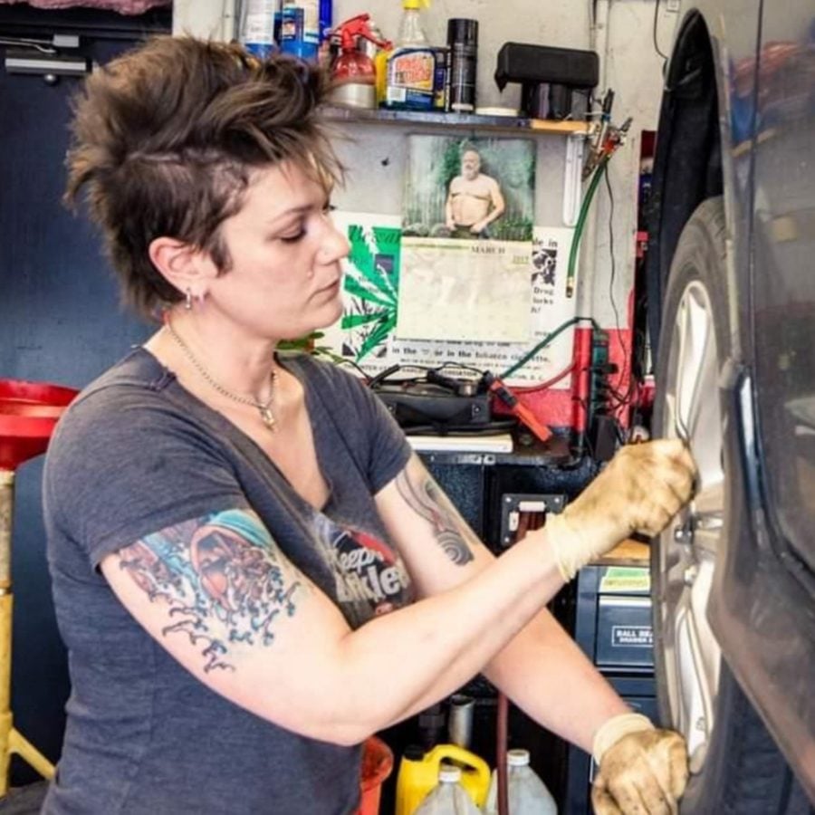 A women working on a broken car