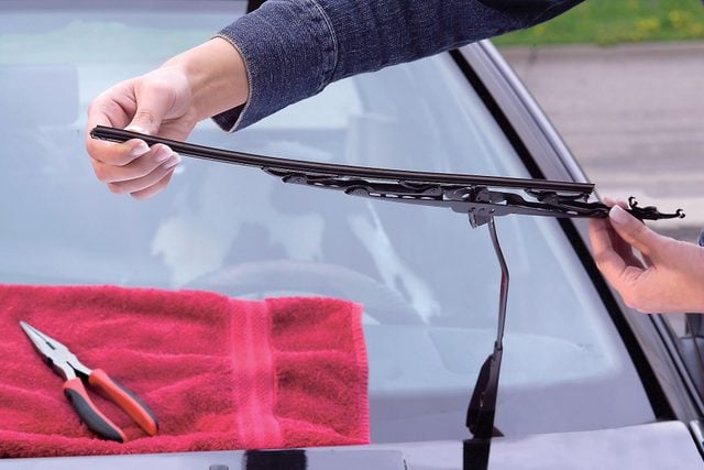 A Close up of wiper blade being removed from a car
