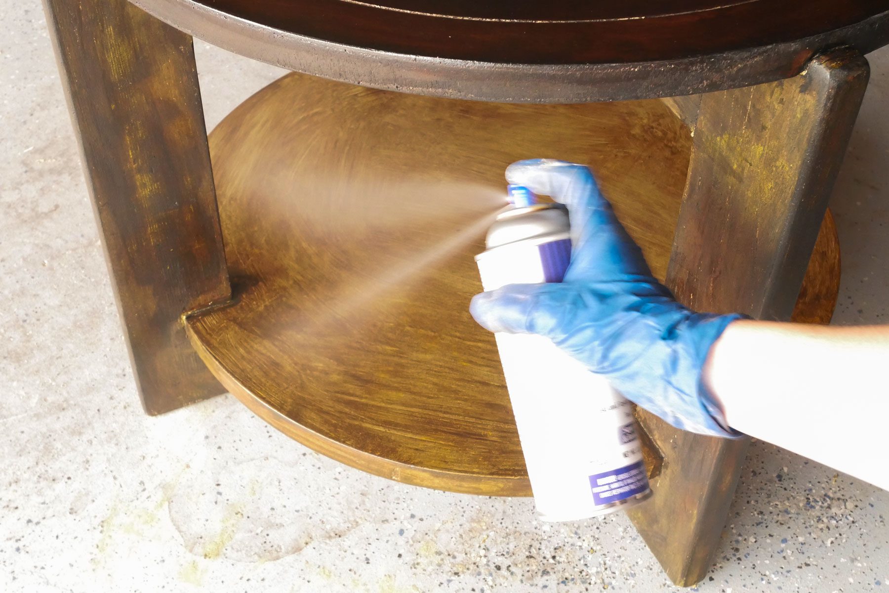 Spraying lacquer on a wooden table
