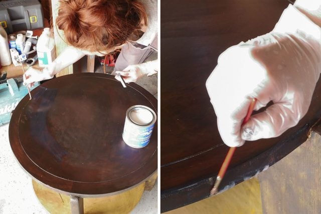 Painting a wooden table with a brush
