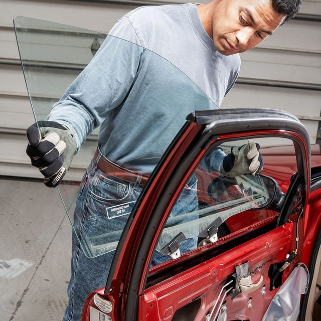 a person removing car's window glass