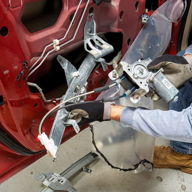a person replacing / repairing power window motor
