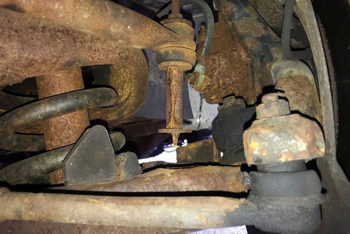  a rusted sway bar link with rubber bushing missing
