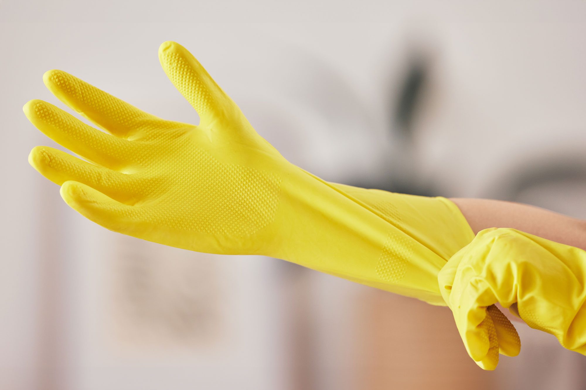 A Person Wearing Yellow Cleaning Gloves