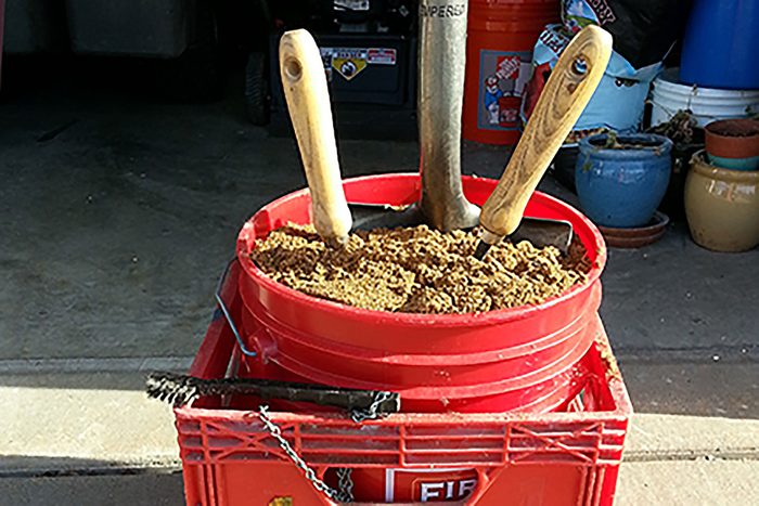 A Bucket filled with tools and dirt