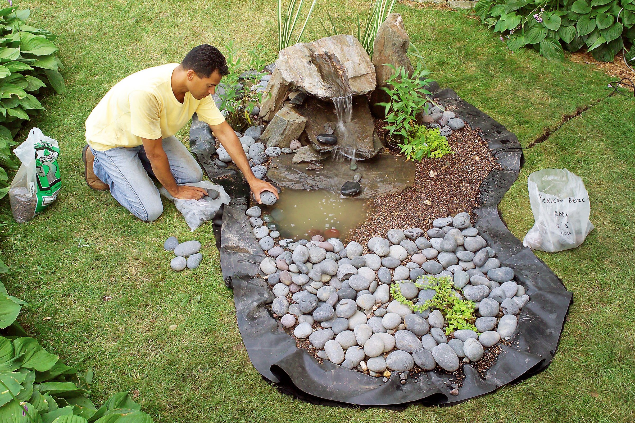 man building a pond in a backyard