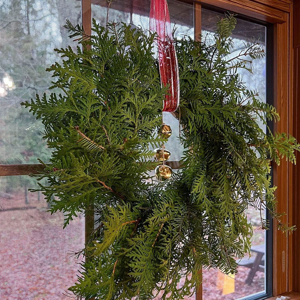 Wreath with bells hanging on a window