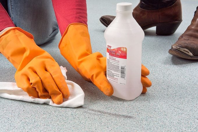 A Person Removing Tough Stains from Vinyl Flooring