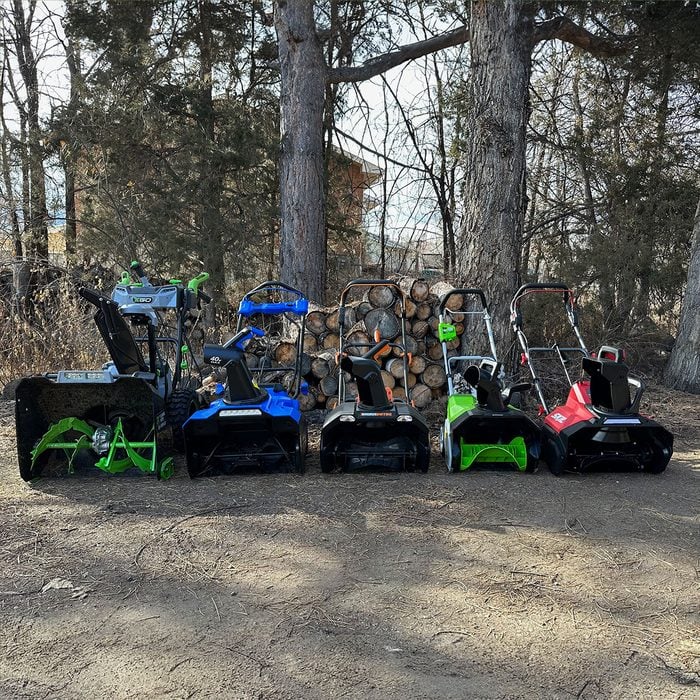 All snow blowers lined up in forest
