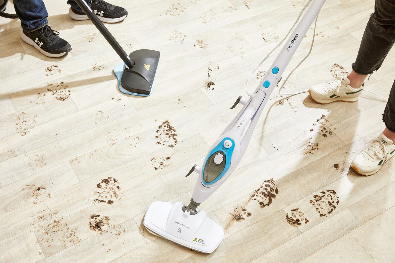 Testing steam cleaners on a dirty wood floor