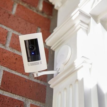 a home security camera attached to the exterior of a home