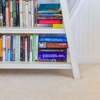 A Bookcase On Floor Carpeting