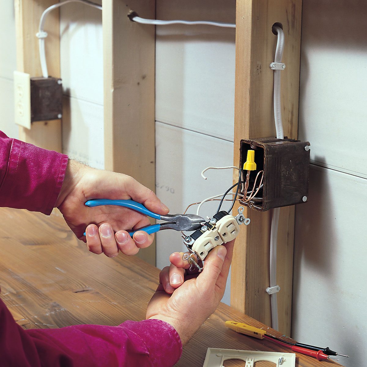 Person repairing the outlet with tools